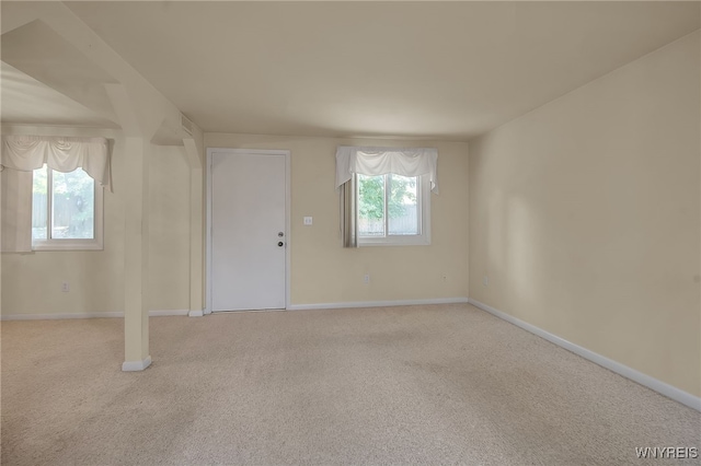 interior space with a healthy amount of sunlight and light colored carpet