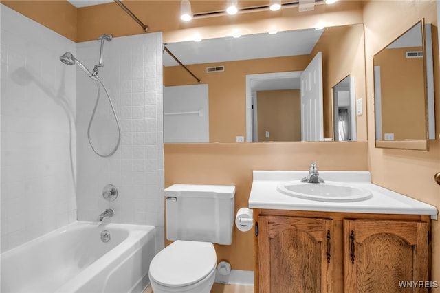 full bathroom with vanity, toilet, and tiled shower / bath