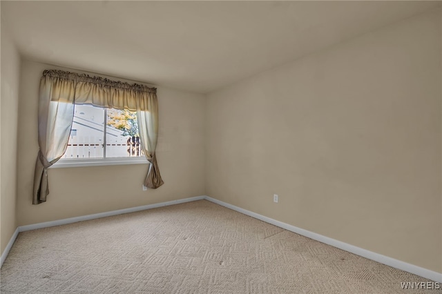 unfurnished room with light carpet