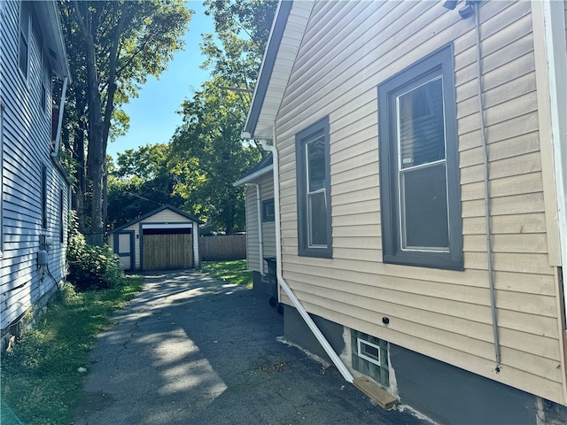 view of side of property featuring a garage and an outbuilding