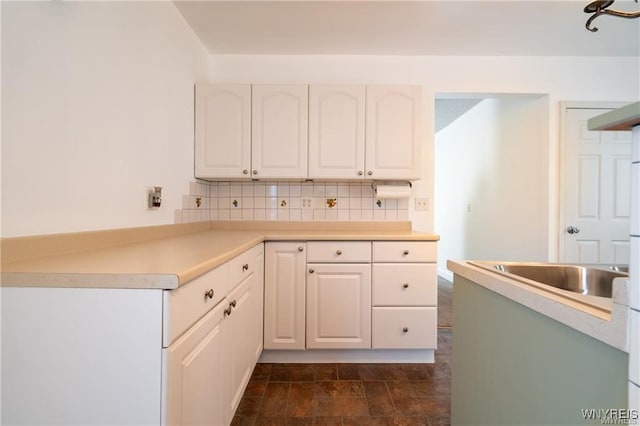 kitchen with decorative backsplash and white cabinets