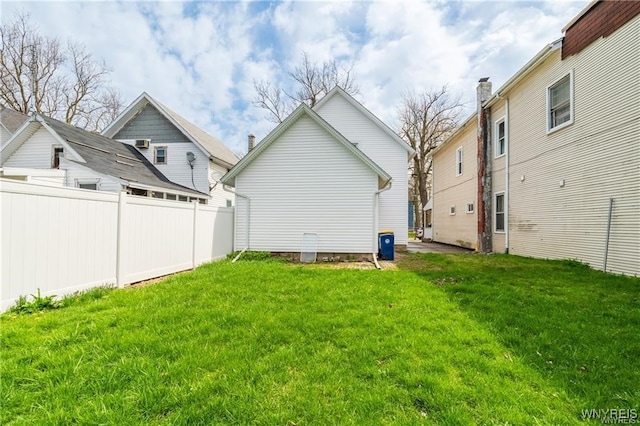 back of property featuring a lawn