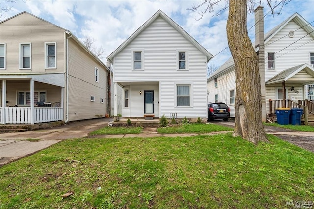 view of property with a porch and a front lawn