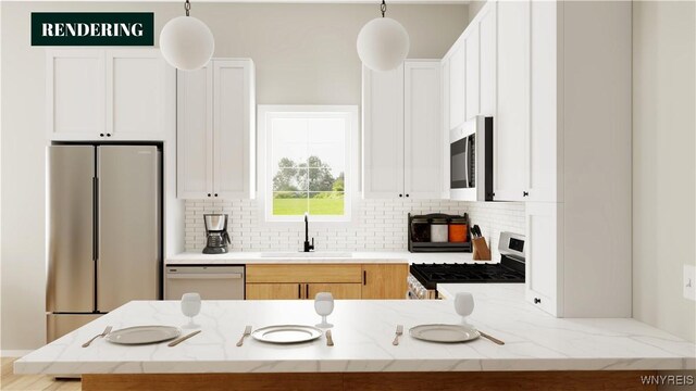 kitchen with sink, stainless steel appliances, tasteful backsplash, decorative light fixtures, and white cabinets