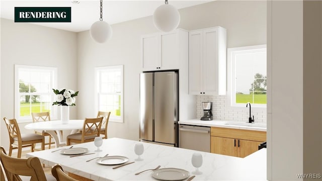 kitchen featuring white cabinets, sink, hanging light fixtures, decorative backsplash, and stainless steel appliances