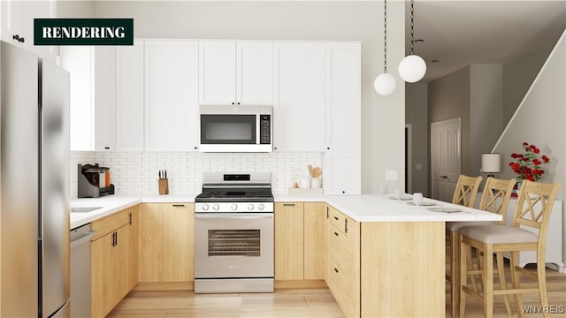 kitchen with a kitchen breakfast bar, light brown cabinets, stainless steel appliances, and decorative light fixtures