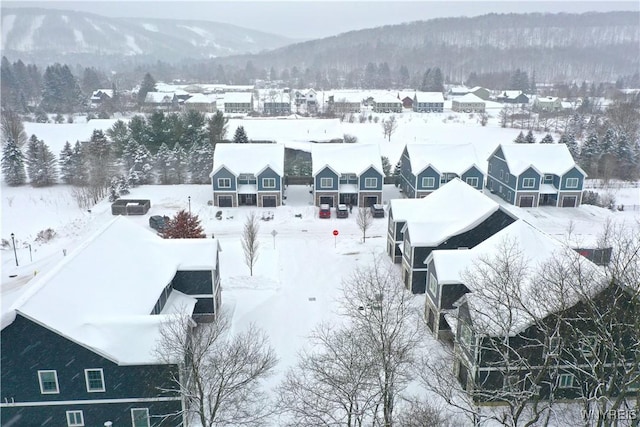 snowy aerial view with a mountain view