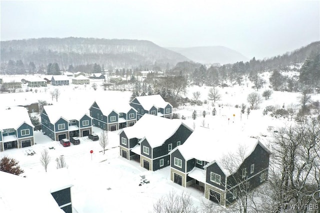 snowy aerial view featuring a mountain view