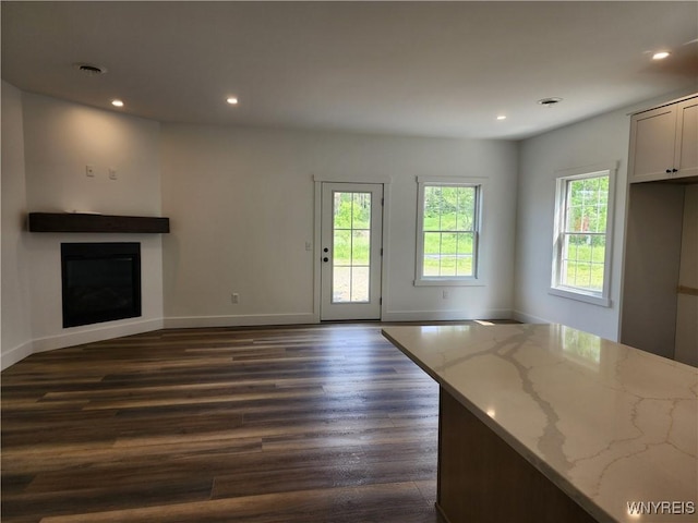 28 Glen Burn Trl, Ellicottville, NY 14731 - unfurnished living room featuring dark wood-style floors, baseboards, recessed lighting, and a fireplace