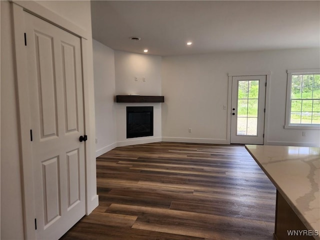 28 Glen Burn Trl, Ellicottville, NY 14731 - unfurnished living room featuring a fireplace, dark wood-type flooring, recessed lighting, and baseboards