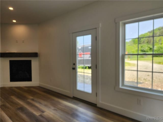 28 Glen Burn Trl, Ellicottville, NY 14731 - unfurnished living room with healthy amount of natural light, wood finished floors, recessed lighting, and baseboards