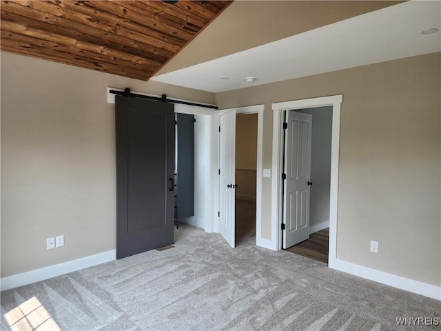 28 Glen Burn Trl, Ellicottville, NY 14731 - unfurnished bedroom featuring wood ceiling, lofted ceiling, carpet floors, baseboards, and a barn door