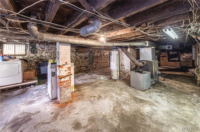 basement with heating unit, gas water heater, and washer / dryer