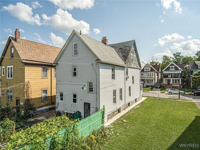 rear view of property with a lawn