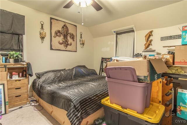 carpeted bedroom featuring lofted ceiling and ceiling fan