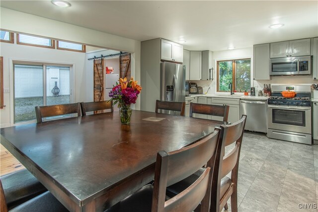 dining room featuring a barn door and sink