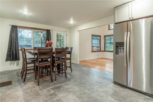 dining area with light hardwood / wood-style flooring and a wealth of natural light