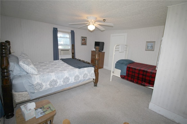 bedroom with a textured ceiling, carpet, ceiling fan, and cooling unit