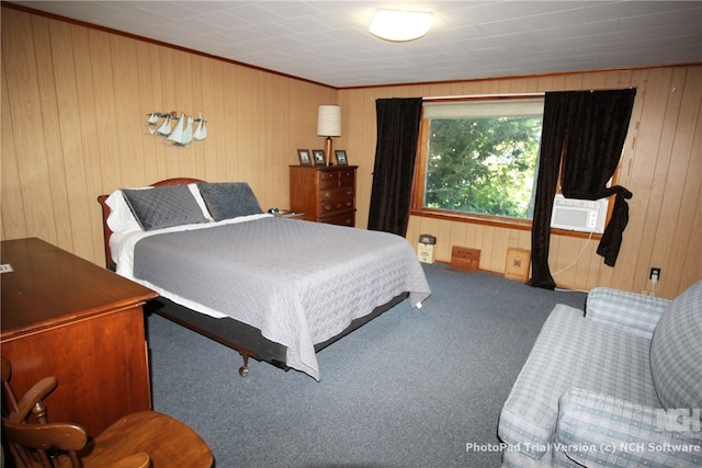 carpeted bedroom featuring cooling unit and wood walls