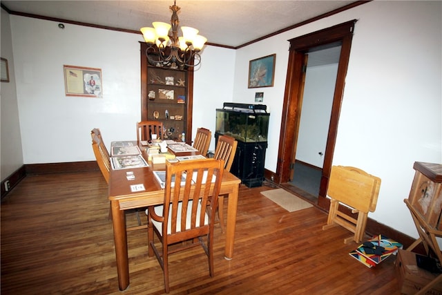 dining space featuring ornamental molding, a chandelier, and dark hardwood / wood-style floors