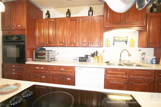 kitchen featuring black oven, dishwasher, and sink