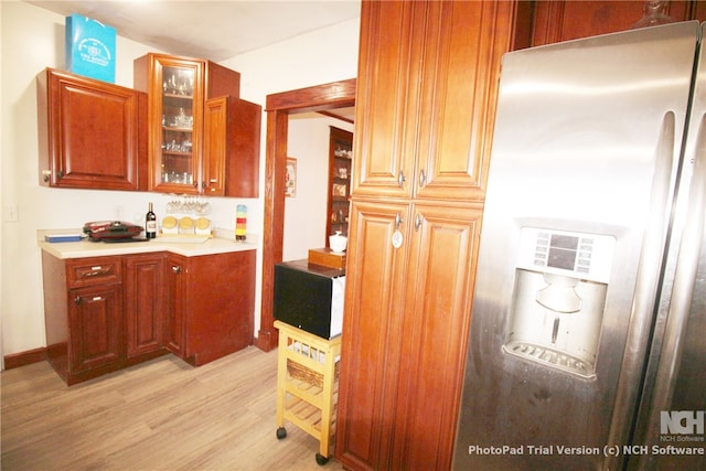 kitchen featuring light hardwood / wood-style flooring and stainless steel refrigerator with ice dispenser