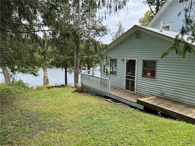 view of yard featuring a deck with water view