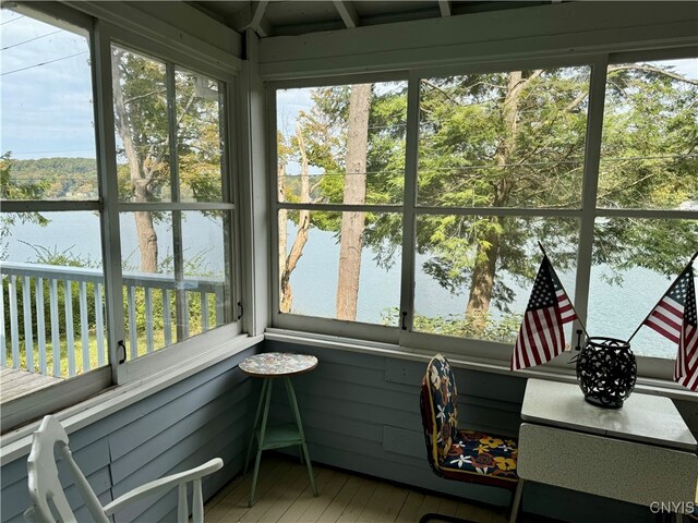 sunroom with a water view and plenty of natural light