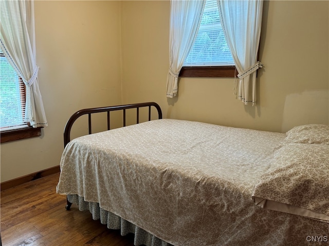 bedroom featuring multiple windows and hardwood / wood-style floors