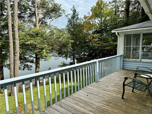 wooden terrace featuring a lawn