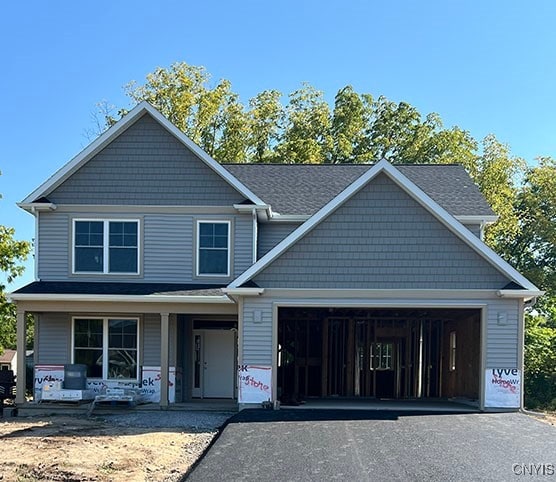 view of front of home featuring covered porch and a garage