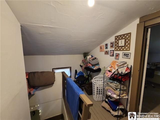 interior space featuring hardwood / wood-style floors and vaulted ceiling