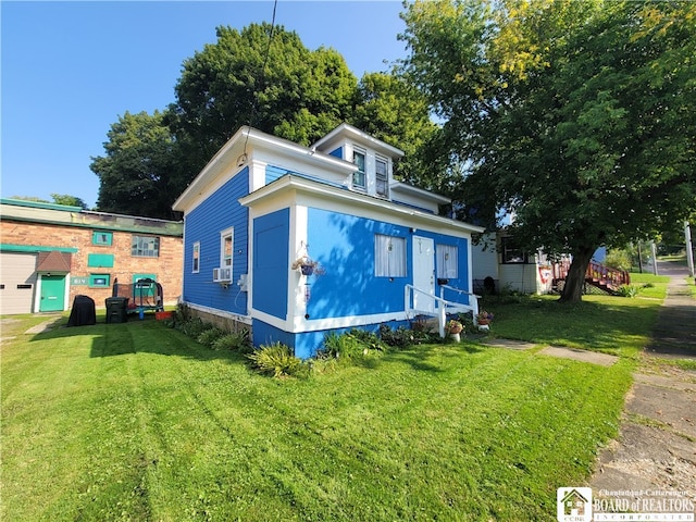 view of front of home with cooling unit and a front yard