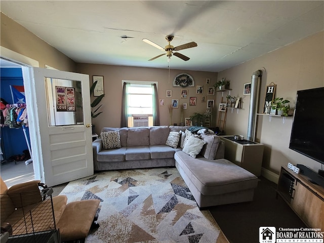 living room with ceiling fan and cooling unit