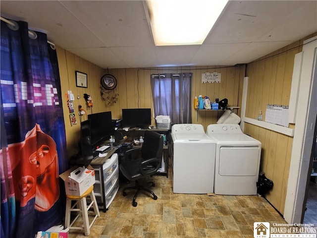 laundry area with washer and clothes dryer and wooden walls