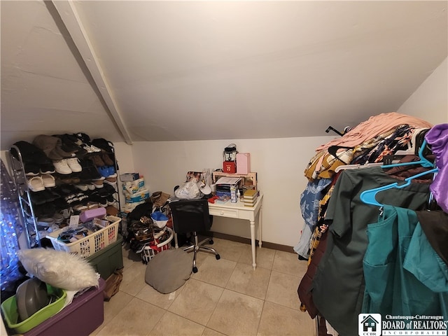 walk in closet with lofted ceiling and light tile patterned floors