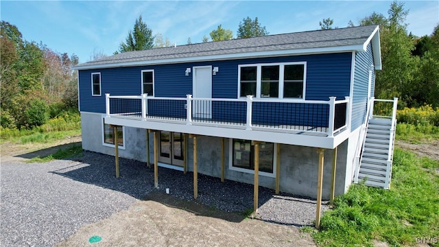 rear view of house featuring a deck