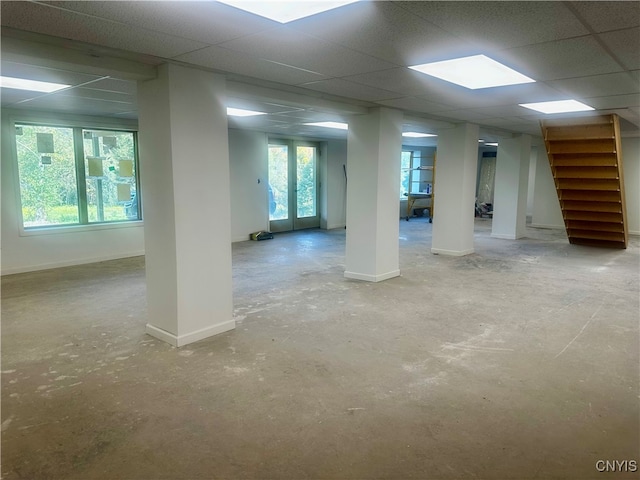 unfurnished room with concrete flooring and a paneled ceiling