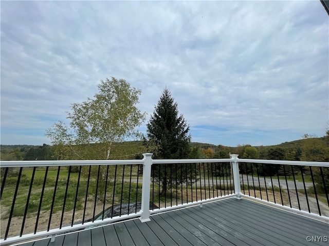 wooden deck with a lawn