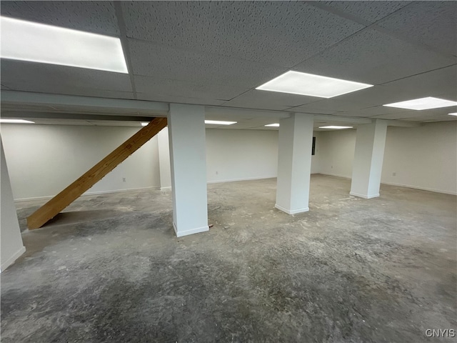 basement with a paneled ceiling