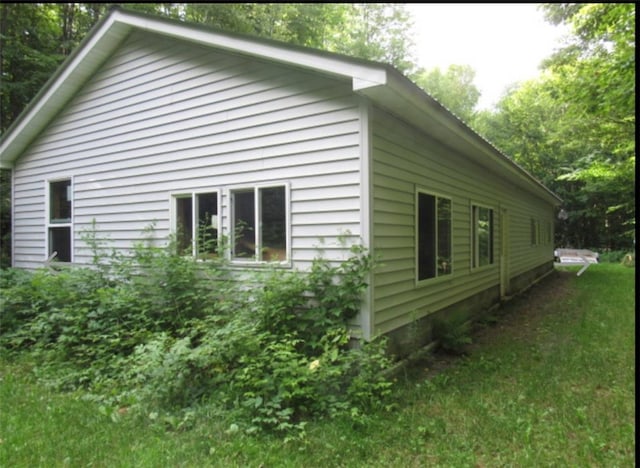 view of home's exterior with a yard