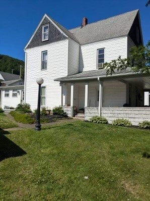 exterior space with a lawn and a porch