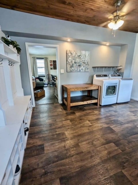 interior space with wood ceiling, dark hardwood / wood-style flooring, independent washer and dryer, and ceiling fan