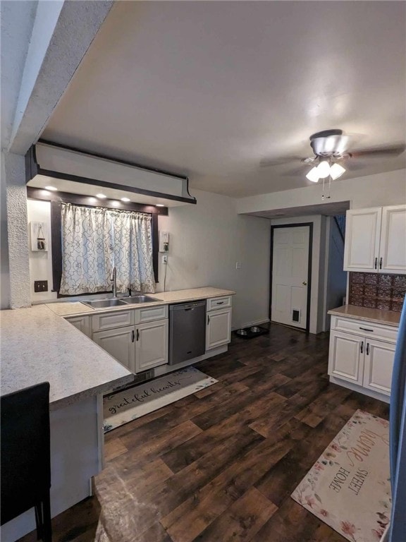 kitchen with ceiling fan, white cabinets, sink, dark wood-type flooring, and dishwasher