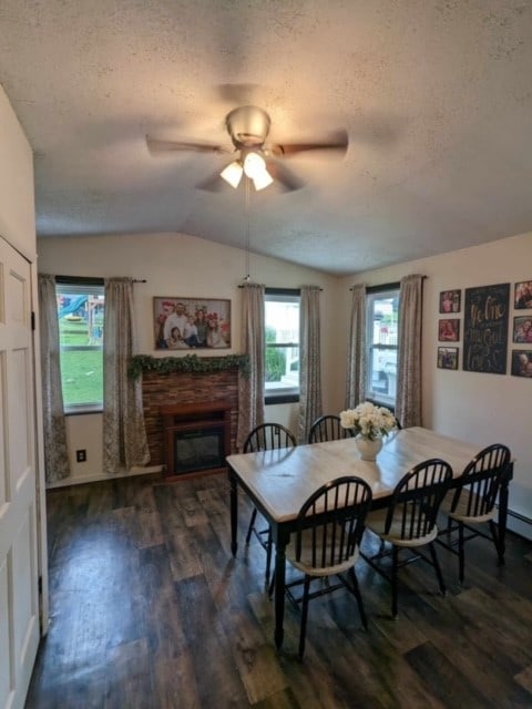 dining room featuring ceiling fan, a textured ceiling, lofted ceiling, and dark hardwood / wood-style floors