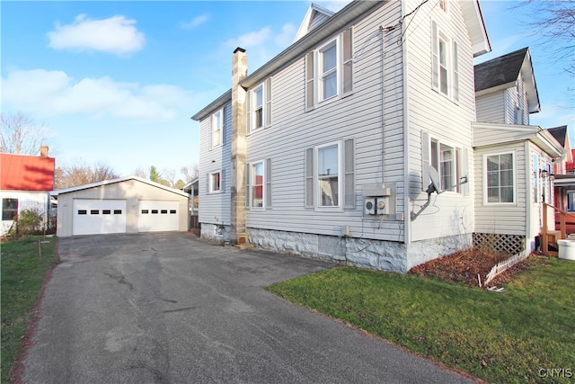 view of home's exterior featuring an outbuilding, a garage, and a lawn