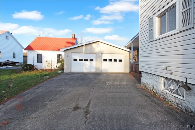 view of front of home featuring a garage and an outdoor structure