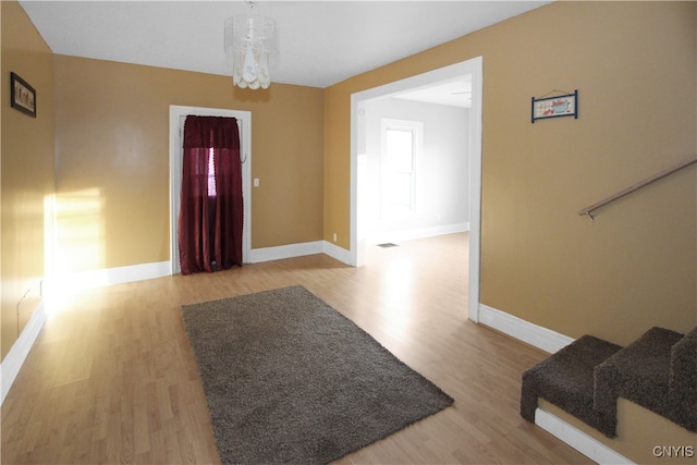 entrance foyer featuring a chandelier and light wood-type flooring