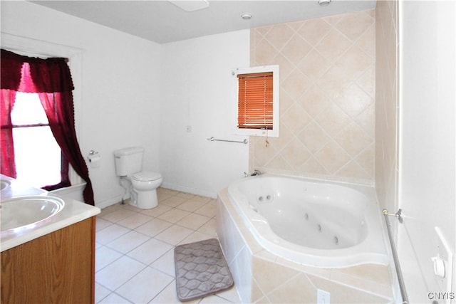 bathroom featuring tile patterned floors, vanity, a relaxing tiled tub, and toilet