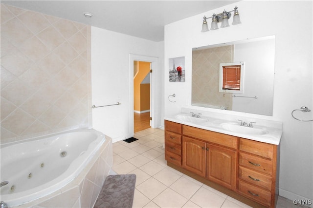 bathroom featuring tile patterned floors, vanity, and tiled tub